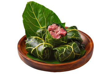 Lu Pulu corned beef cooked in coconut milk in taro leaves in wooden bowl, isolated on white transparent background, concept of traditional Polynesian food