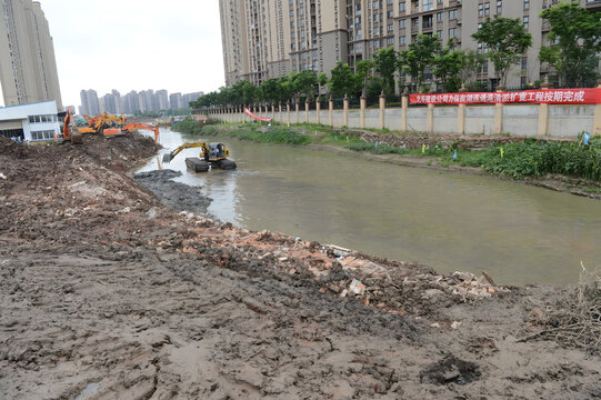 Excavators Dredging River in Urban Construction Project