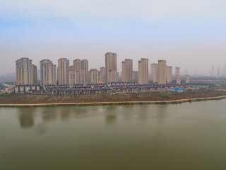 Obraz premium Chutian Residential Waterfront Aerial View with Modern High-Rise Development