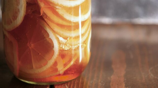 新鮮な輪切りレモンに注いだ蜂蜜が上がってくる動画。ハチミツレモンシロップ。