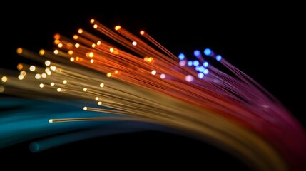 Close up of glowing colorful fiber optic strands against a dark background representing data transmission and connectivity