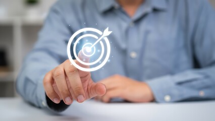 Hand pointing at glowing circular target icon with concentric rings and arrow, futuristic technology concept