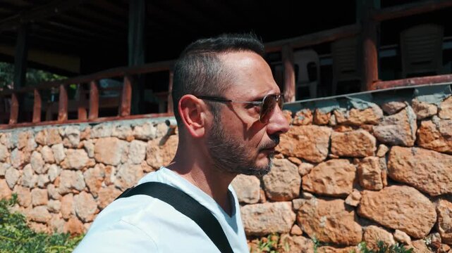 A tourist visit Kalek&ouml;y (Simena), a historic coastal village with its ancient Simena Castle overlooking the bay in Antalya, Turkey.