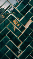 Vertical close-up of glossy, green ceramic subway tiles arranged in a traditional running bond pattern with contrasting white grout. The beveled edges of the vintage-style tiles catch reflections, 