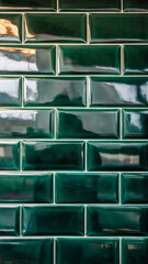 Vertical close-up of glossy, green ceramic subway tiles arranged in a traditional running bond pattern with contrasting white grout. The beveled edges of the vintage-style tiles catch reflections, 