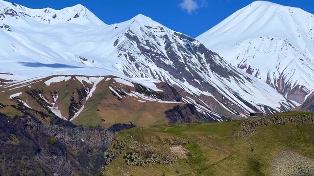 GUDAURI, GEORGIA - APRIL 26, 2024: Scenic view of the Devil's Gorge and the Arch of Friendship. The Caucasus Mountains in the area of the Peoples' Friendship Arch on the Georgian Military Road. 4K
