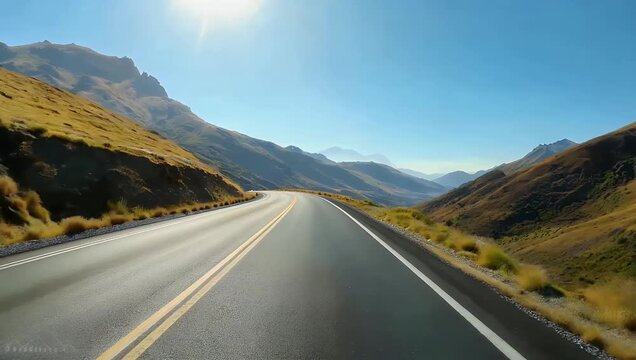 POV 4K footage of winding asphalt road meandering through hilly terrain under bright sunny skies capturing driving perspective natural landscape immersive outdoor motion stock 