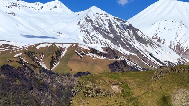 GUDAURI, GEORGIA - APRIL 26, 2024: Scenic view of the Devil's Gorge and the Arch of Friendship. The Caucasus Mountains in the area of the Peoples' Friendship Arch on the Georgian Military Road. 4K