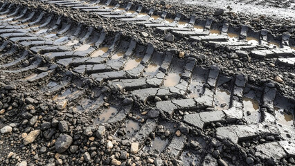 Quarry machine tracks in mud, heavy machinery imprint with industrial ground texture and construction terrain detail, suitable for editorial use, industrial reports, and background imagery