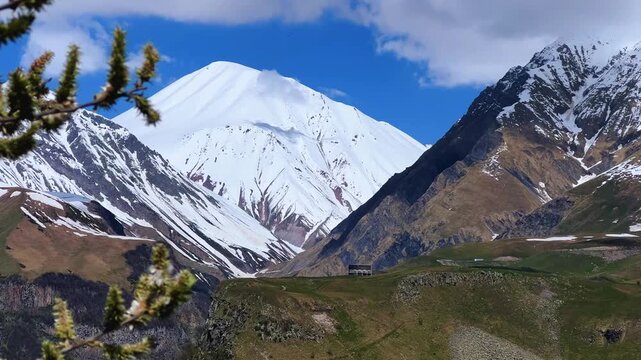 GUDAURI, GEORGIA - APRIL 26, 2024: Scenic view of the Devil's Gorge and the Arch of Friendship. The Caucasus Mountains in the area of the Peoples' Friendship Arch on the Georgian Military Road. 4K