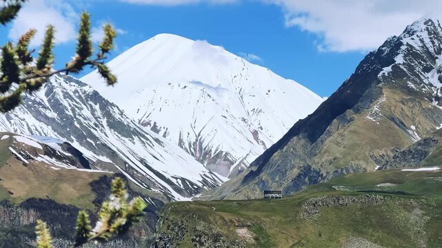 GUDAURI, GEORGIA - APRIL 26, 2024: Scenic view of the Devil's Gorge and the Arch of Friendship. The Caucasus Mountains in the area of the Peoples' Friendship Arch on the Georgian Military Road. 4K