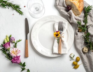 Elegant table setting with white plate, flowers, and cutlery