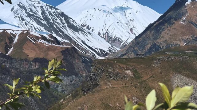 GUDAURI, GEORGIA - APRIL 26, 2024: Scenic view of the Devil's Gorge and the Arch of Friendship. The Caucasus Mountains in the area of the Peoples' Friendship Arch on the Georgian Military Road. 4K