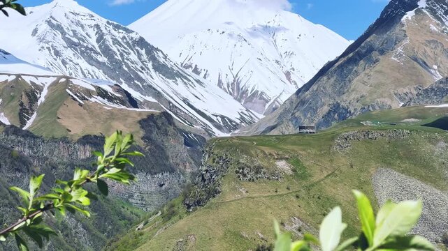 GUDAURI, GEORGIA - APRIL 26, 2024: Scenic view of the Devil's Gorge and the Arch of Friendship. The Caucasus Mountains in the area of the Peoples' Friendship Arch on the Georgian Military Road. 4K