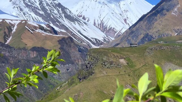 GUDAURI, GEORGIA - APRIL 26, 2024: Scenic view of the Devil's Gorge and the Arch of Friendship. The Caucasus Mountains in the area of the Peoples' Friendship Arch on the Georgian Military Road. 4K