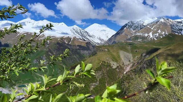 GUDAURI, GEORGIA - APRIL 26, 2024: Scenic view of the Devil's Gorge and the Arch of Friendship. The Caucasus Mountains in the area of the Peoples' Friendship Arch on the Georgian Military Road. 4K
