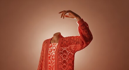 A headless figure in a patterned dress and a textured coral cardigan reaches a hand upwards against a soft gradient background.