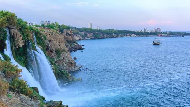 View of the Nizhny Duden waterfalls in Antalya, Turkey. Waterfalls fall from a rocky cliff into the Mediterranean Sea. The cascade is formed by the Duden River, one of the rivers in southern Anatolia.