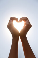Hands Making Heart Shape in Sunlight - Love and Romance Gesture