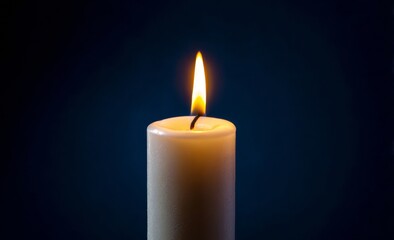 Burning Candle Flame on Dark Blue Background.