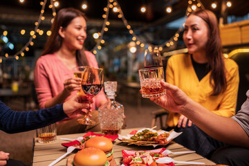 young couple celebrating with champagne at night