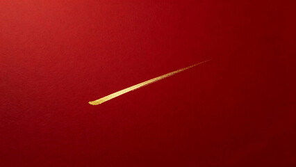 A close-up shot of a single golden chopstick against a plain red background, highlighting its elegant simplicity