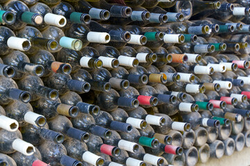 Rows of Dusty Empty Wine Bottles in a Dark Cellar or Warehouse