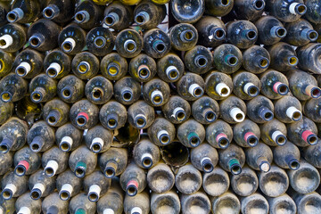 Rows of Dusty Empty Wine Bottles in a Dark Cellar or Warehouse