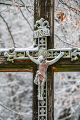 Crucified Jesus Christ on the wooden cross in the forest.