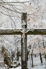 Crucified Jesus Christ on the wooden cross in the forest.