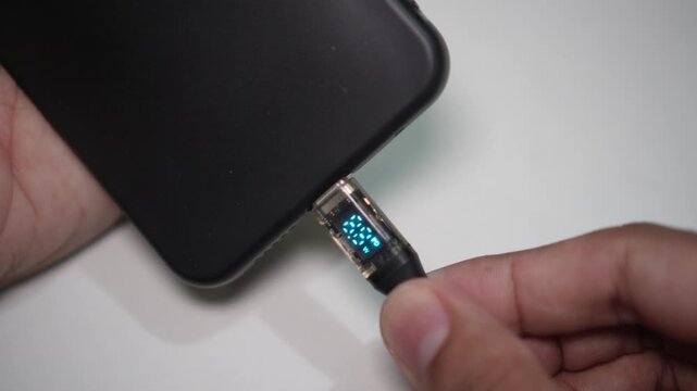 Close-up video of plugging a USB Type-C charger into a smartphone Type-C port, showing an active Power Delivery (PD) fast charging indicator.