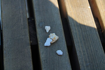 white small stones, on a wooden background,