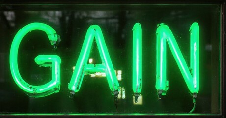 Bright green neon sign spells GAIN. Dark background emphasizes glowing letters. Simple, bold typography creates strong visual impact.
