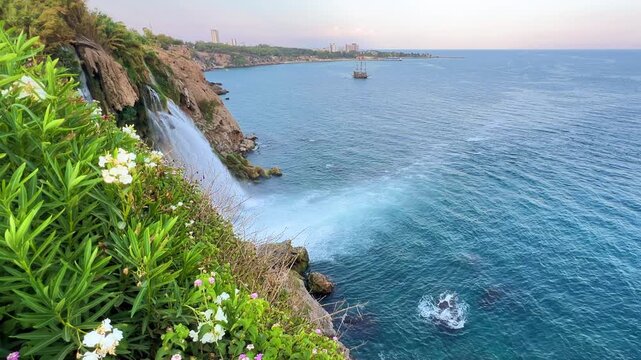 View of the Nizhny Duden waterfalls in Antalya, Turkey. Waterfalls fall from a rocky cliff into the Mediterranean Sea. The cascade is formed by the Duden River, one of the rivers in southern Anatolia.
