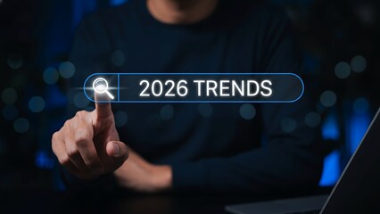 Futuristic glowing search bar showing '2026 TRENDS' with magnifying glass icon, finger touch
