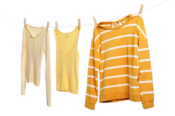 Different clothes drying while hanging on clothesline against white background © New Africa