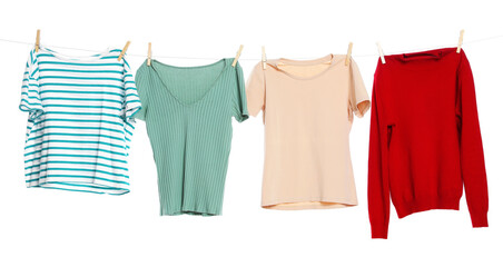 Different clothes drying while hanging on clothesline against white background