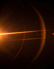 Bright orange light with streaks on dark background, simulating a lens flare