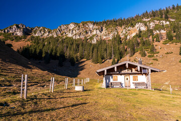 A hike along the Bavarian Chiemgau on the way to the Hochfelln peak and stop by beautiful farmers sheds