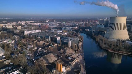 Modern data center facility supporting digital transformation alongside a river in an urban landscape of Berlin. Gorgeous aerial view fly push forward drone - Powered by Adobe