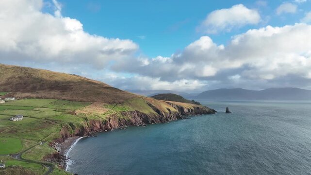 Ireland beautiful land drone rising to reveal Kenmare bay and the rugged Mountains of Kerry from Kinnard beach Dingle