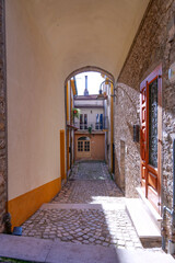A narrow street among the old houses of Capriati a Volturno, a small town in the province of Caserta, Italy.