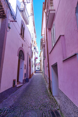 A narrow street among the old houses of Capriati a Volturno, a small town in the province of Caserta, Italy.