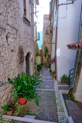 A narrow street among the old houses of Capriati a Volturno, a small town in the province of Caserta, Italy.