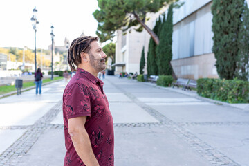 Latin American man exploring urban city, enjoying European travel and local culture