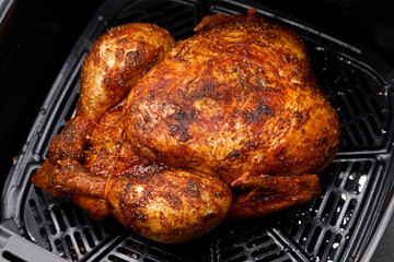Top view of a crispy whole chicken prepared in an air fryer, delicious, grilled, homemade chicken