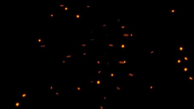 Flying fire embers and glowing sparks floating on a black background for visual effects overlay