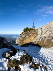 Chiemgau as a Bavarian Region with a beautiful summit cross peak view and a true hike destination 