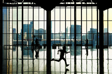 silhouette of a man behind bars