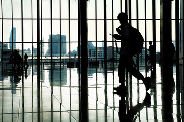 silhouette of a woman behind a gate